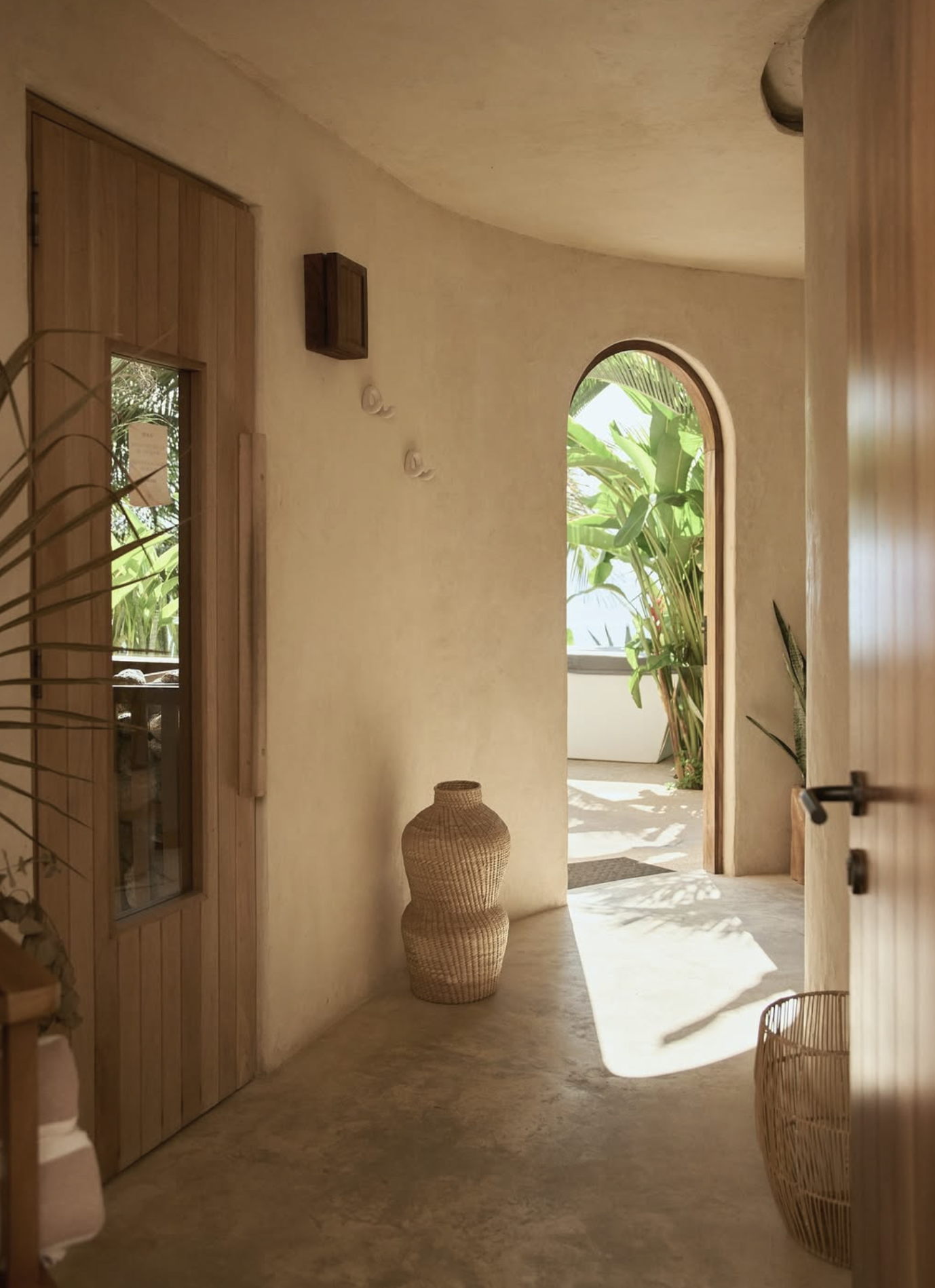 La Joya interior with arched doorway and tropical light