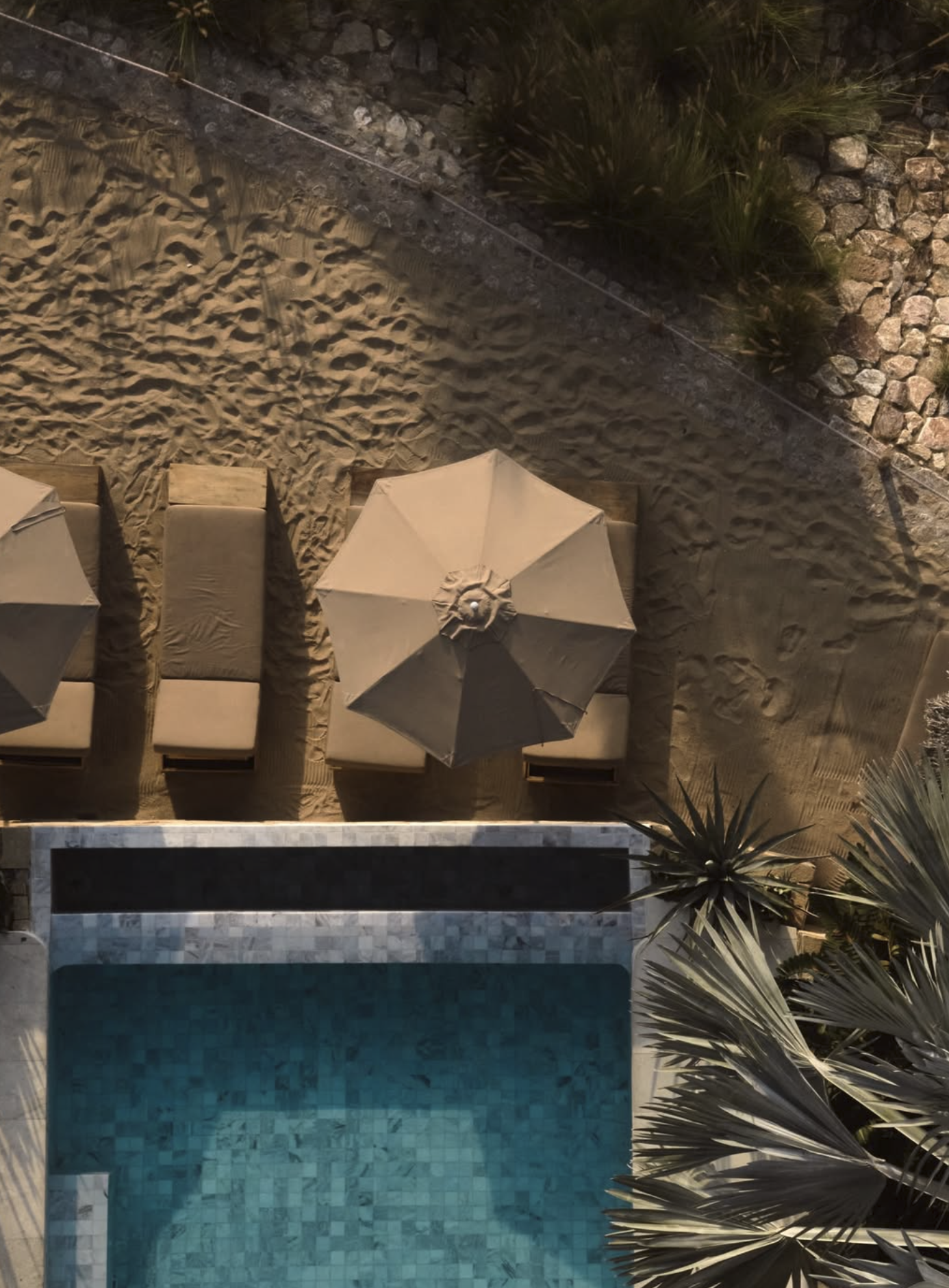 Bird's eye view of infinity pool with lounge chairs